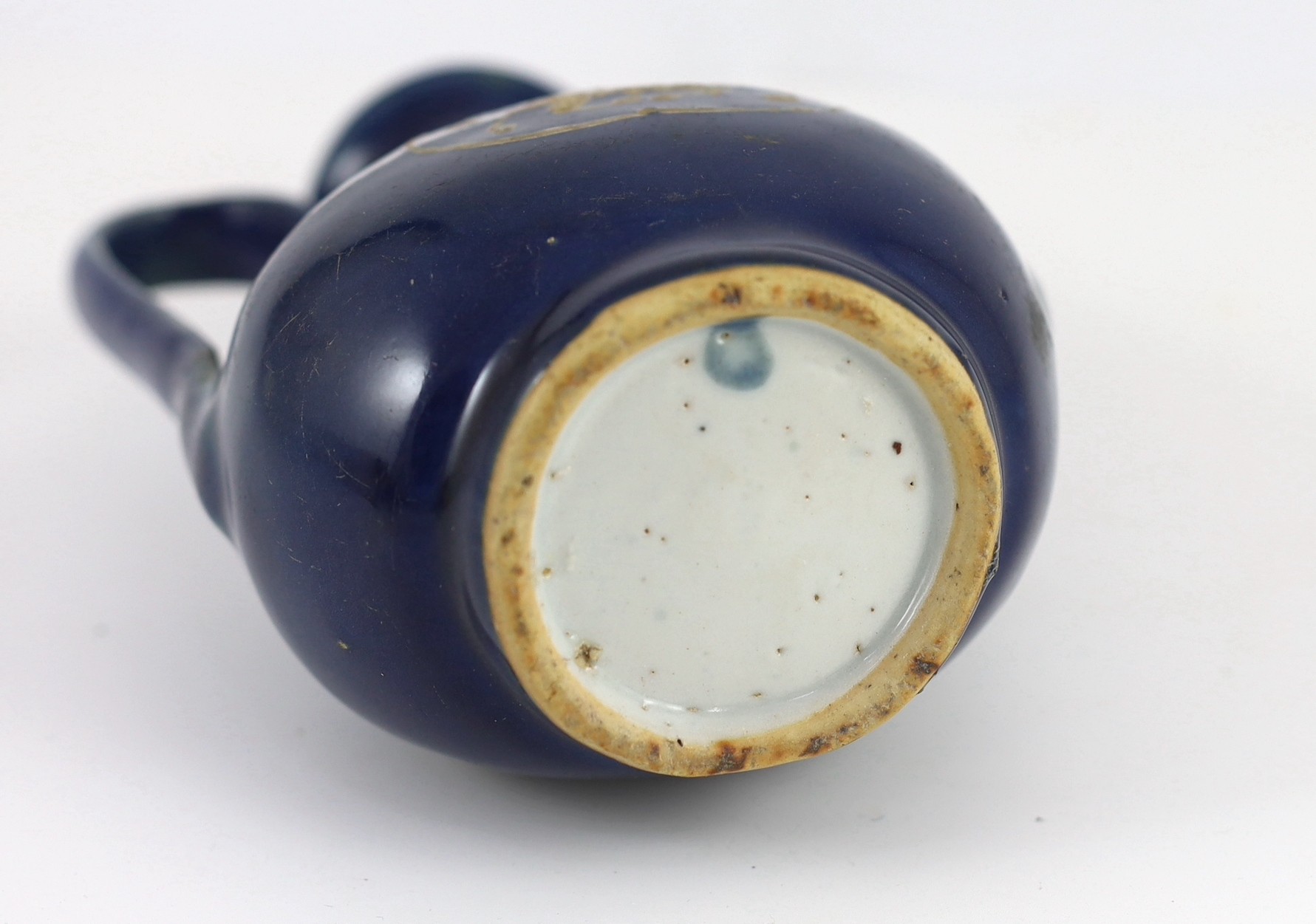 A Chinese late Ming blue glazed and slip decorated ‘qilin’ ewer, for the Islamic market, 19.5cm high, handle and tip of spout restored, wear